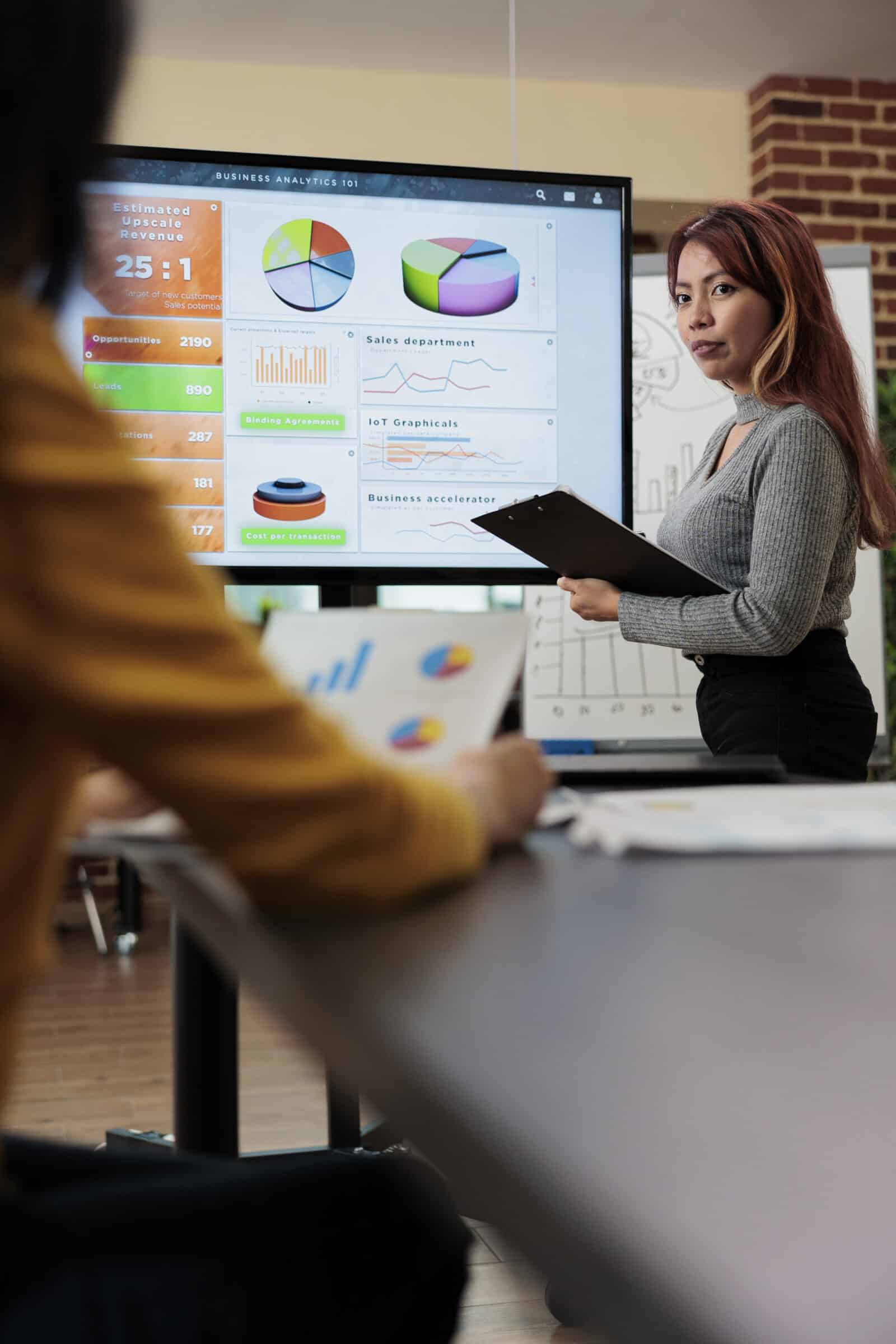 Businesswoman explaining management statistics to asian manager