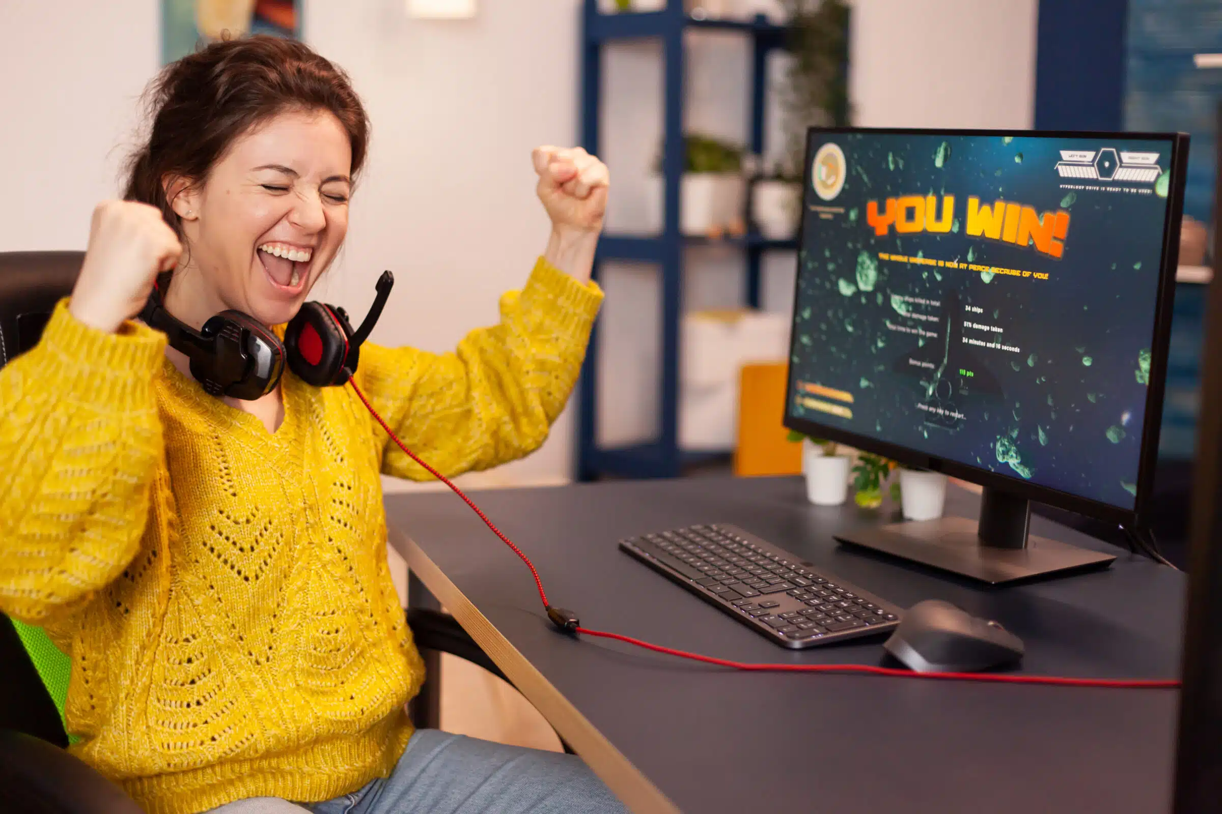 Joyful player celebrates victory winning space shooter video game